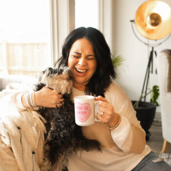 laughing woman with small dog and cute mug